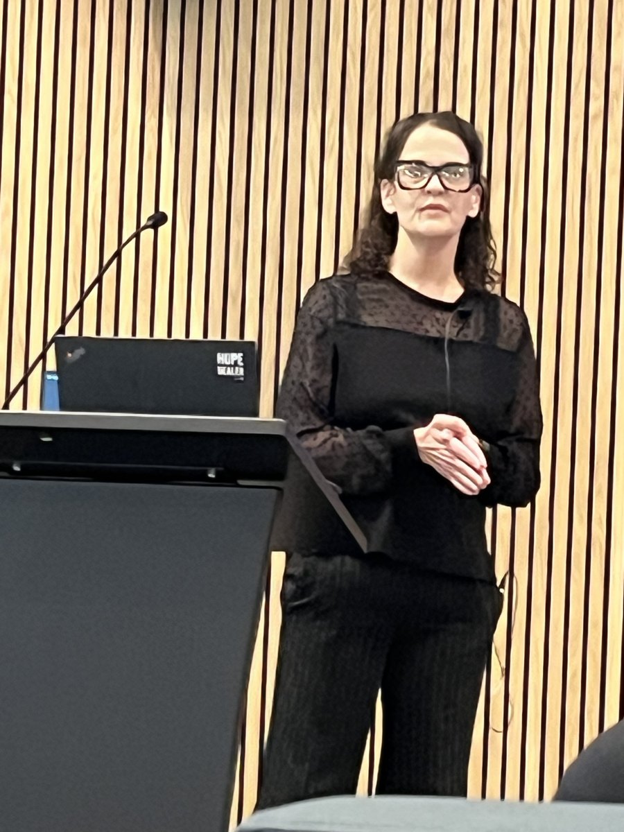 Dr. Payne speaking at a conference podium